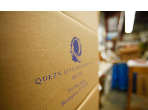 cardboard shipping box with QCP logo